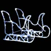 A white and light blue illuminated sleigh decoration against a black background. Podgląd zdjęcia produktu