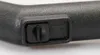 A close-up shot of a black plastic handle with a small black cap or button. Produktbild-Vorschau