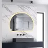 A modern bathroom with a large, illuminated, semi-circular mirror above a dark vanity and a gray sink.