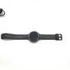 A smartwatch with a black strap is laid out flat on a white background. Náhled obrázku produktu
