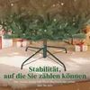 Close-up of the base of a Christmas tree with gifts in the background. Produktbild-Vorschau