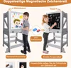 Two children are using a double-sided magnetic drawing board. One child is drawing on the whiteboard side, and the other is drawing on the blackboard side. There are also diagrams and text explaining the product's features. Produktbild-Vorschau