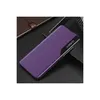 A purple flip case for a smartphone is shown on a dark surface, with a notebook in the background. Produktbild-Vorschau