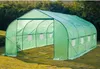 A green tunnel greenhouse set up on a grassy lawn with trees in the background. Voir les images du produit