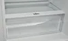 A close-up view of a transparent drawer inside a refrigerator. Produktbild-Vorschau