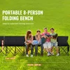People sitting on a portable folding bench in a grassy outdoor area. Anteprima dell’immagine prodotto