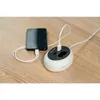 A smartphone is being charged by a Blaupunkt power strip on a wooden table. Produktbild-Vorschau