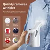 A hand holding a white garment steamer against a blue shirt, with a collage of different fabric types and clothing items shown in circular insets. Podgląd zdjęcia produktu