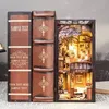 A DIY book nook kit designed to look like a stack of vintage books, with one book opened to reveal a miniature scene. Voir les images du produit