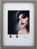 A framed picture of a woman with dramatic makeup and hairstyle. Produktbild-Vorschau