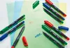 Several STABILO OHPen universal permanent markers are displayed on colored translucent sheets, with some text written on the sheets. Produktbild-Vorschau