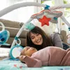 A mother and baby playing on a playmat with a gymini. Produktbild-Vorschau