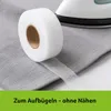 A roll of hemming tape is shown on a gray fabric, with an iron in the background. Produktbild-Vorschau