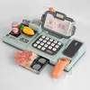 A toy cash register with accessories on a white background. Produktbild-Vorschau