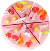 A toy cake cut into slices, decorated with various toy fruits and pastries. Podgląd zdjęcia produktu