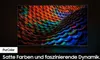 A television screen displaying a colorful, abstract image, with text overlay at the bottom. Produktbild-Vorschau