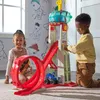 Two children playing with a Paw Patrol Tower HQ toy in a room with Paw Patrol themed wallpaper. Náhľad obrázku produktu
