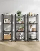 Three black shelving units filled with various home decor and kitchen items, against a white wall. Produktbild-Vorschau