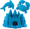 A blue sandcastle, dolphin, and crab made of kinetic sand. Voir les images du produit