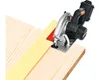 A cordless circular saw is positioned on a piece of wood, with a guide strip next to it. Náhled obrázku produktu