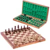 A wooden chess set with pieces in a box and on a board. Produktbild-Vorschau