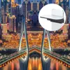 A product shot of a smartphone camera reflection mirror is superimposed over a nighttime cityscape with a bridge. Voir les images du produit