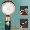 A shower head with a stop button and water spray demonstration. Produktbild-Vorschau
