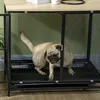 A pug is inside a black metal dog crate with a wooden top. Náhľad obrázku produktu