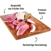 Raw duck meat pieces arranged on a wooden cutting board with text overlays. Náhľad obrázku produktu