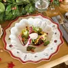 A festive Christmas table setting with a salad on a decorative plate. Produktbild-Vorschau