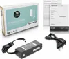 A product shot of a laptop AC adapter, its box, and documentation. Produktbild-Vorschau
