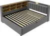 A grey upholstered bed frame with a wooden headboard featuring shelves and a padded headboard with integrated lighting. Produktbild-Vorschau