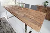 A dining table made of reclaimed wood with metal legs, set in a dining room with chairs and a sideboard. Produktbild-Vorschau