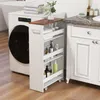 A narrow rolling cart filled with toiletries and towels is placed next to a washing machine and a bathroom vanity. Podgląd zdjęcia produktu