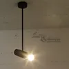 A black pendant light fixture hangs from a concrete ceiling. Podgląd zdjęcia produktu