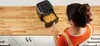 A woman is using an air fryer filled with french fries on a kitchen counter. Náhled obrázku produktu