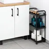 A black rolling cart with toiletries and toilet paper sits next to a white cabinet with a wooden countertop. Anteprima dell’immagine prodotto