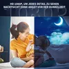A mother and child are sitting on a bed, with the image split to show daytime on the left and nighttime on the right, symbolizing the product's night vision capability. Produktbild-Vorschau