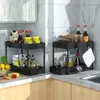Two black two-tier kitchen organizers filled with various kitchen items like bottles, jars, and food items, placed on a kitchen countertop. Náhled obrázku produktu