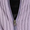A close-up view of a zipper on a purple, corduroy-like fabric. Anteprima dell’immagine prodotto