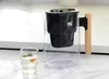 A water filter pitcher and a glass of water are placed on a countertop. Podgląd zdjęcia produktu