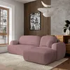A modern living room with a pink corduroy sectional sofa, a large window, and wooden wall paneling.