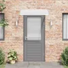 A gray and transparent door canopy mounted above a gray door on a brick wall. Produktbild-Vorschau