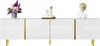 A white, high-gloss TV cabinet with gold accents and legs, decorated with a floral arrangement and two decorative busts. Anteprima dell’immagine prodotto