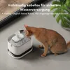A cat drinks water from a pet water fountain. Produktbild-Vorschau