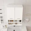 A white wall-mounted bathroom cabinet with two doors and open shelves below, above a sink. Náhled obrázku produktu