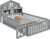 A grey wooden children's bed with a house-shaped headboard and integrated shelving, shown from a slightly elevated side angle against a white background. Podgląd zdjęcia produktu