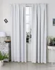 A pair of light gray curtains hangs in front of a window, with a small table and chest of drawers visible on either side. Produktbild-Vorschau