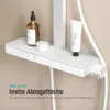A close-up of a white shower system shelf with toiletries on it. Náhľad obrázku produktu