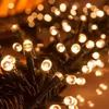 A close-up view of many small, warm white LED lights on dark wires. Produktbild-Vorschau